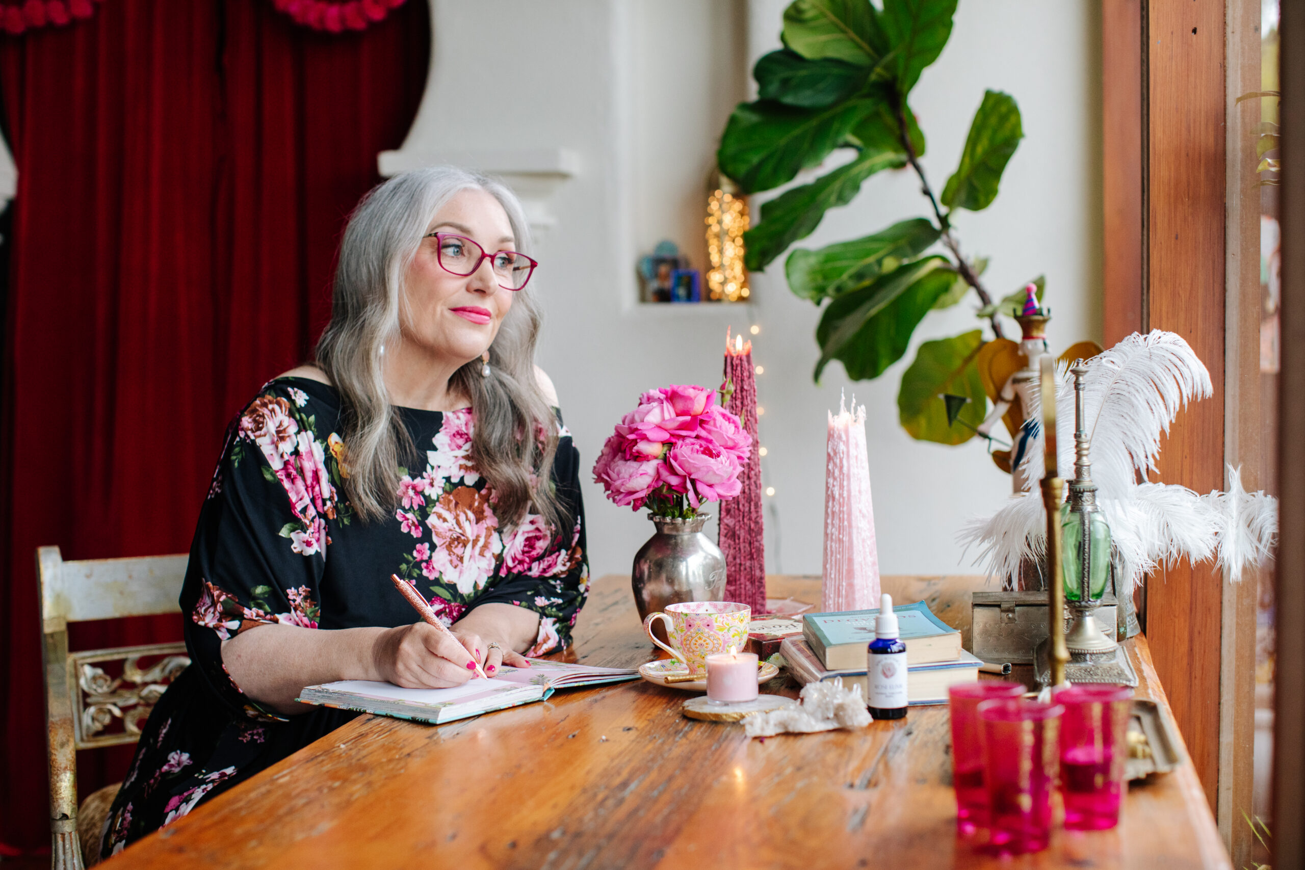 business woman sitting at a desk journalling